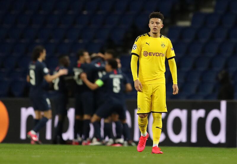 A dejected Jadon Sancho after Juan Bernat celebrates scoring for Paris St Germain in their Champions League match in France in February. Reuters