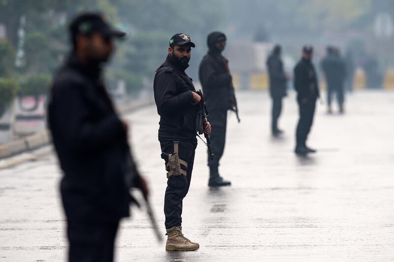 Security personnel stand guard on a street near the Pindi Cricket Stadium in Rawalpindi. AFP