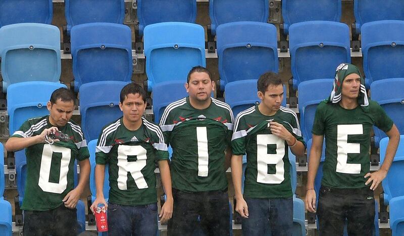 Mexico fans wearing shirts that spell out Oribe Peralta's name at the World Cup match against Cameroon on Friday in Natal, Brazil. Peralta later scored the only goal in Mexico's 1-0 win. Gabriel Bouys / AFP