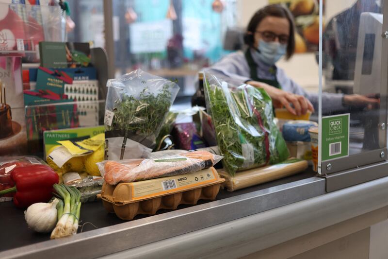 A cashier scans goods at a Waitrose supermarket in London, UK. AFP