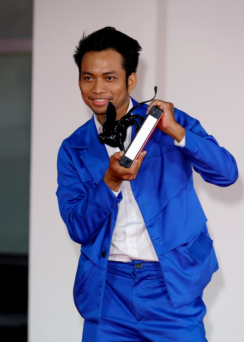 Director Neang Kavich poses, on behalf of Piseth Chhun, with the Best Actor Orizzonti Award for 'White Building'. Getty Images