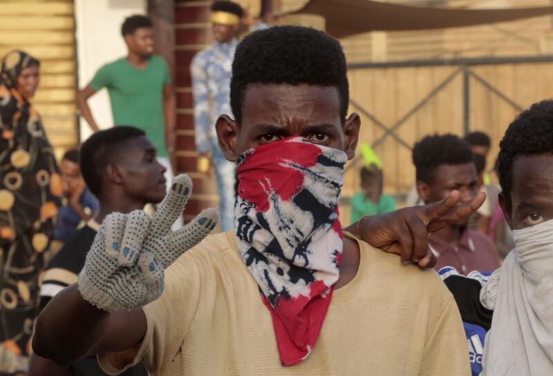 Sudanese protesters flash the victory gesture during a rally in the capital Khartoum to condemn the "massacre" of five demonstrators including four high school students at a rally in a central town of Al-Obeida. AFP