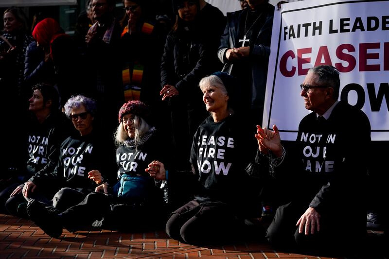 Demonstrators wear shirts calling for a ceasefire during a Jewish Voice for Peace rally in Seattle, Washington state. AP