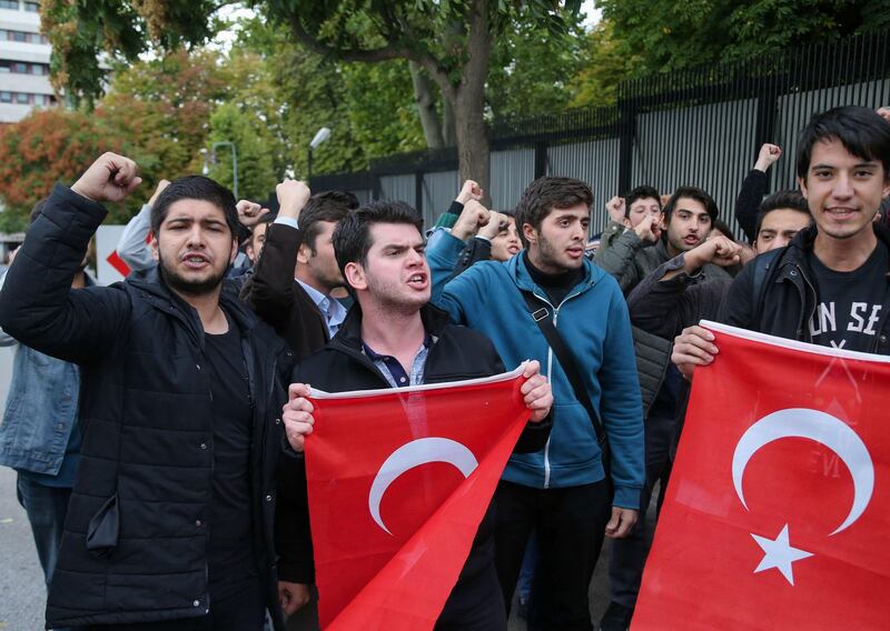 Members of the Youth Union of Turkey (TGB) wave flags as they protest in front of the US embassy in Ankara after US President made threats against Turkey. AFP