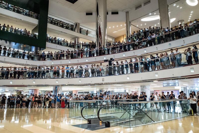 Residents and protesters sing songs and shout slogans as they gather at a shopping mall after business hours in Tai Koo district in Hong Kong, China. Getty