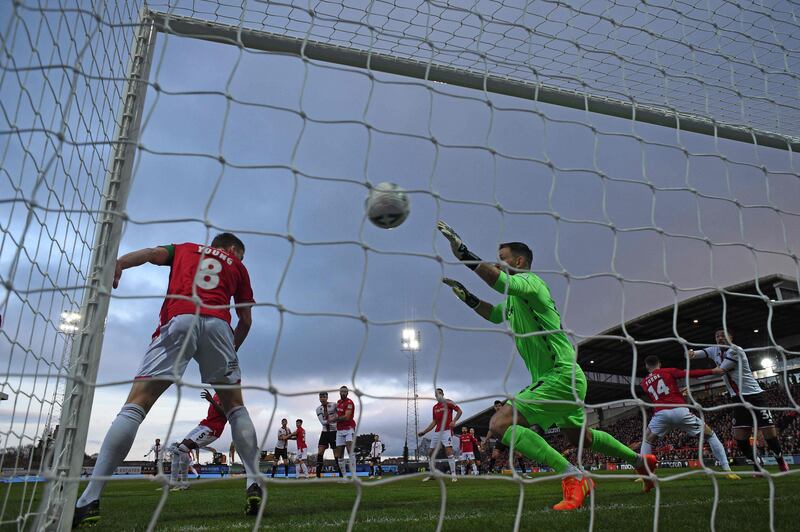 Wrexham goalkeeper Mark Howard is beaten by Sheffield United's Oli McBurnie for the opening goal. AFP