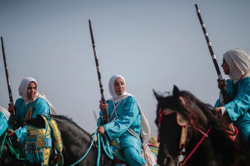 In this Thursday, July 25, 2019 photo, a female troupe prepares to take part in Tabourida, a traditional horse riding show also known as Fantasia, in the coastal town of El Jadida, Morocco.