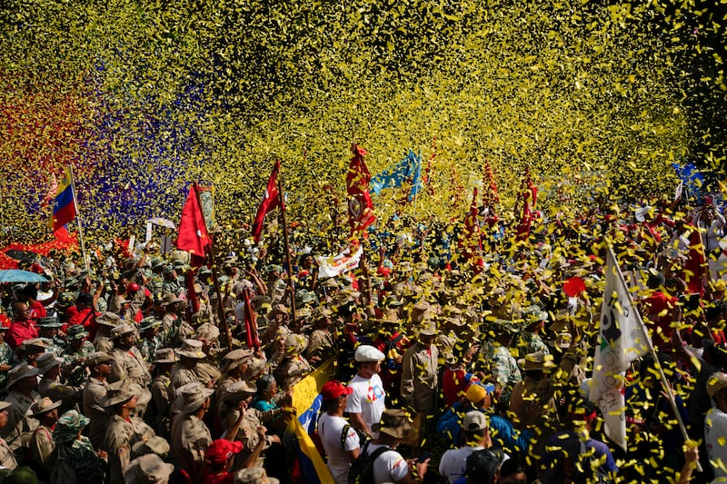 Confetti showers Bolivarian Militia members and government supporters at a march commemorating a 2004 speech by late President Hugo Chavez that is considered by his supporters a key anti-imperialist moment in the history of his Bolivarian Revolution in Caracas. AP