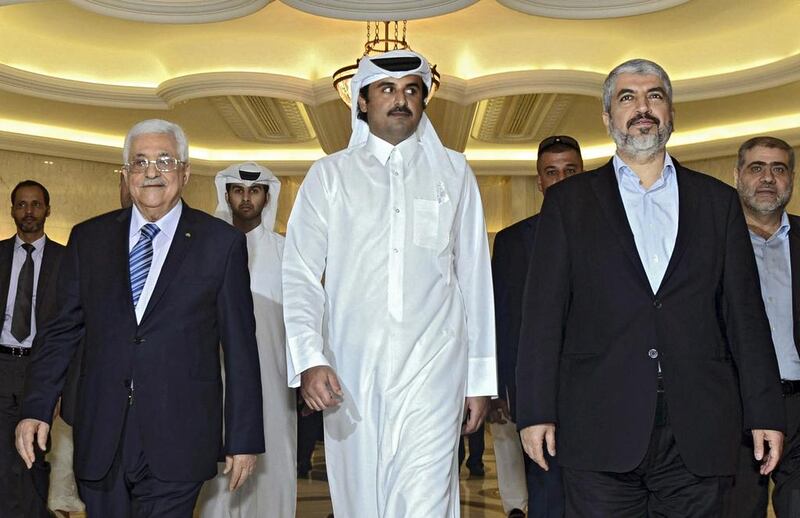 From left: The Palestinian president Mahmoud Abbas, the Emir of Qatar Sheikh Tamim bin Hamad Al Thani, and exiled Hamas leader Khaled Meshaal arrive for a meeting in Doha on August 21, 2014. Thaer Ghanaim/ Palestinian President Office / Reuters