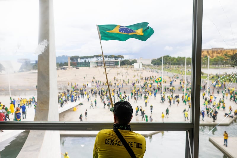 Supporters of Brazil's former president Jair Bolsonaro demonstrate outside Congress in Brasilia. Reuters

