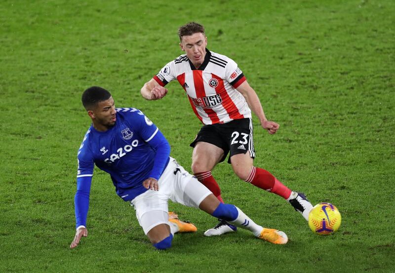 Ben Osborn of Sheffield United is tackled by Everton's Mason Holgate. Getty
