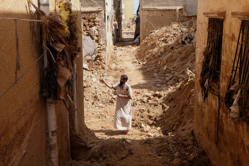 A man inspects damaged buildings in the aftermath of the flooding that hit Libya. Experts believe climate change made flood damage 50 times more likely. Photo: Reuters