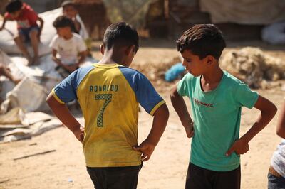 Palestinian youths play football in a poor neighbourhood in Gaza amid soaring temperatures and power cuts. AFP
