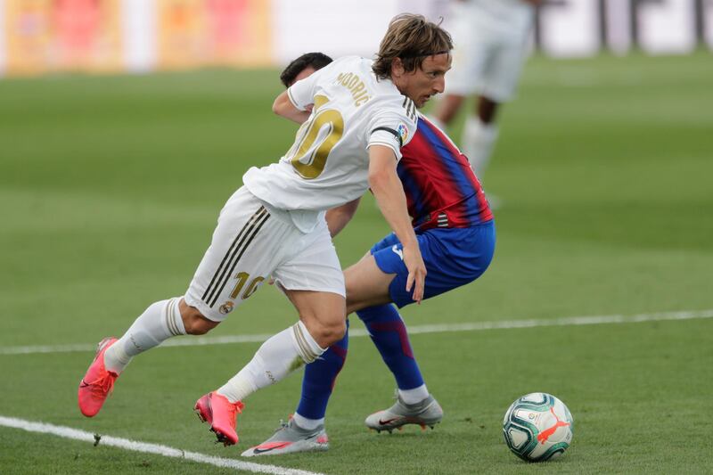 Real Madrid's Luka Modric goes past Eibar's Edu Expositio. AP