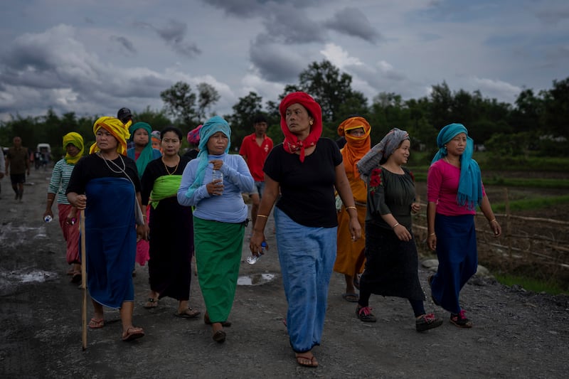 Members of Meira Paibis, a powerful vigilante group of Hindu majority Meitei women, march towards the site of a gunfight in Kangchup, Manipur. AP