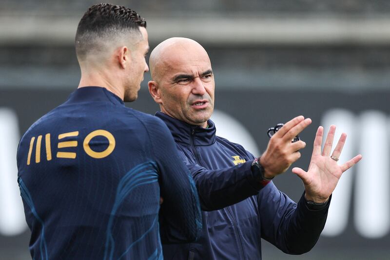 Portugal manager Roberto Martinez talks to Cristiano Ronaldo during a training session in Oeiras. EPA