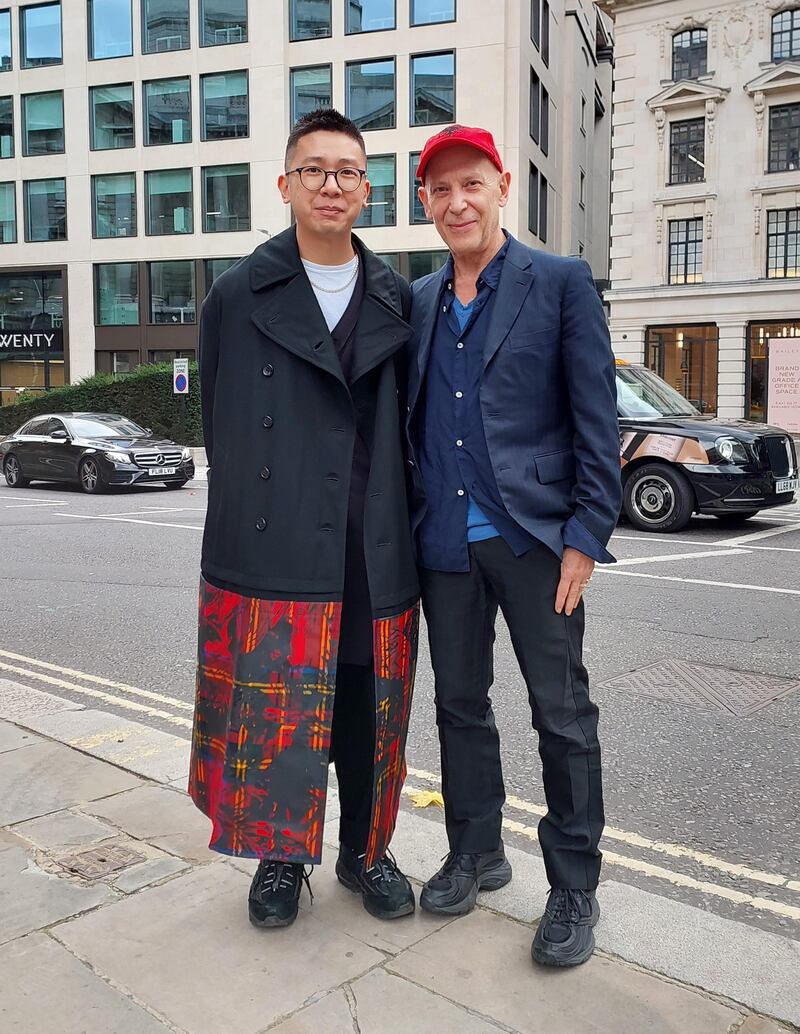 A coat trimmed with printed tartan and a matching red baseball cap.