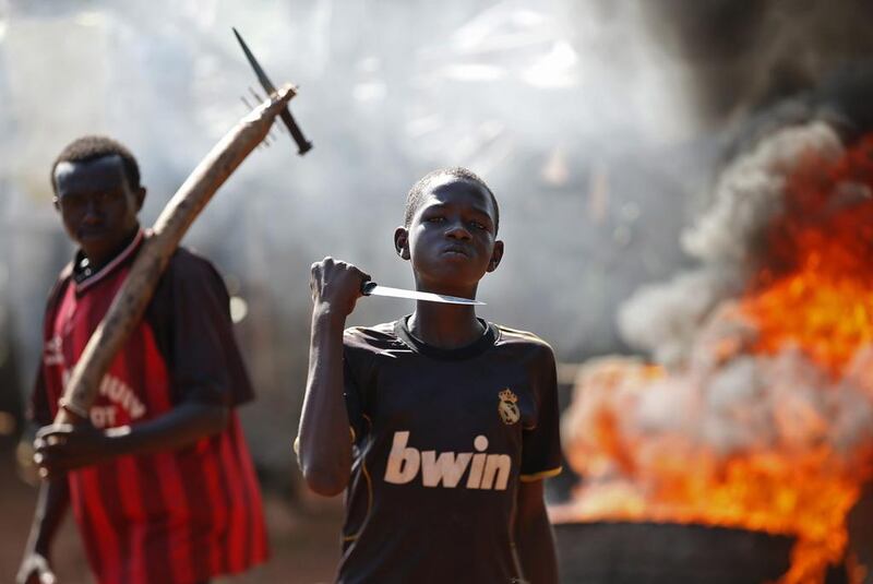 A boy gestures in front of a barricade on fire during a protest after French troops opened fire at protesters blocking a road in Bambari in the Central African Republic. Goran Tomasevic / Reuters