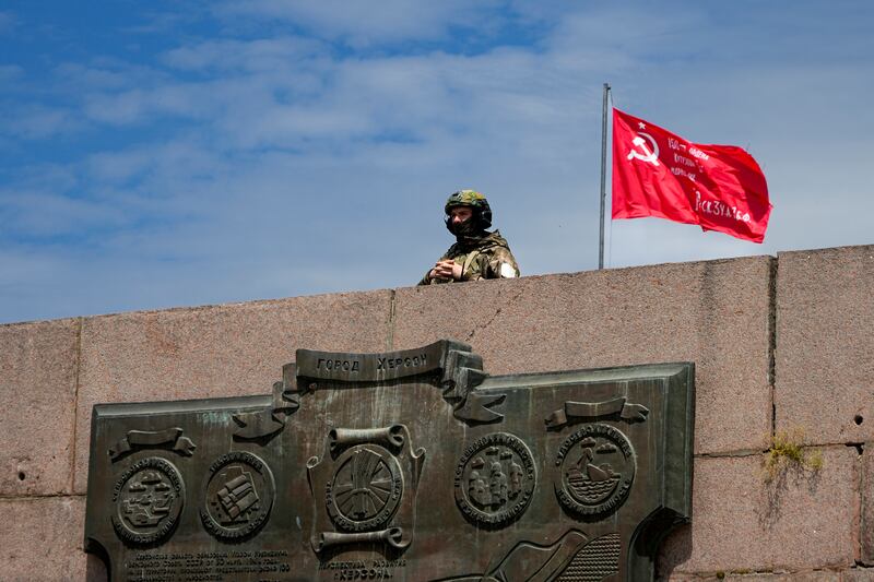A Russian soldier guards a monument in the Kherson region, where 20,000 troops face being cut-off and defeated, western officials say. AP