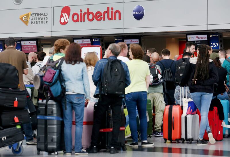 Flight passengers crowd in front of the desk of German airline Air Berlin at the airport in Duesseldorf, western Germany, on September 12, 2017, after the troubled airline had to cancel flights due to "operational reasons". / AFP PHOTO / dpa / Roland Weihrauch / Germany OUT