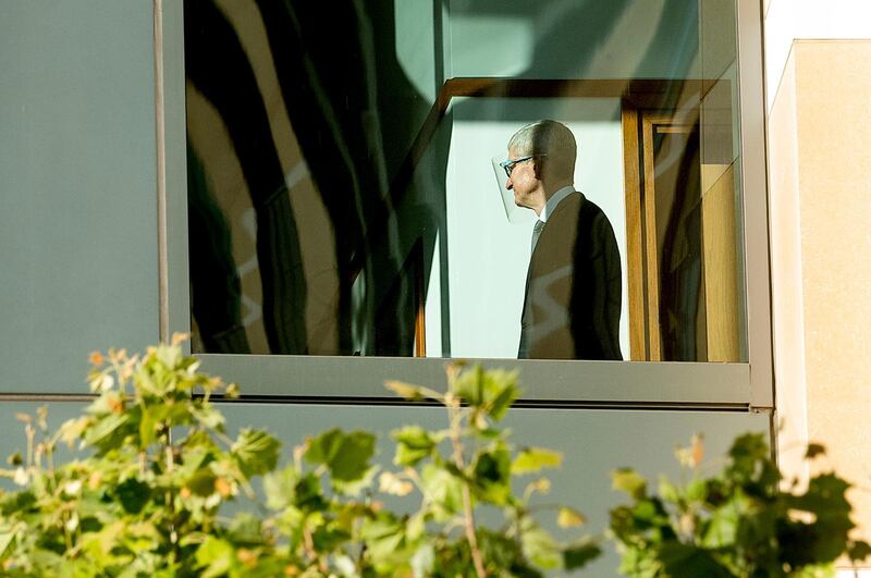 Apple CEO Tim Cook walks through the Ronald V. Dellums building, Friday, May 21, 2021, in Oakland, Calif. Cook is expected to take the witness stand Friday to defend the company's iPhone app store against charges that it has grown into an illegal monopoly â€” one far more profitable than his predecessor Steve Jobs envisioned when it opened up 13 years ago. (AP Photo/Noah Berger)