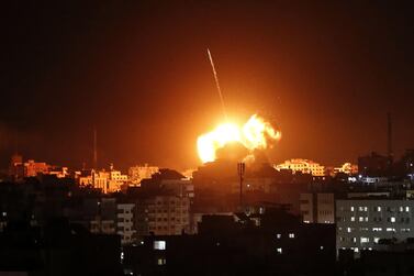 TOPSHOT - A ball of fire lights the sky above a building believed to house the offices of Hamas chief in Gaza, Ismail Haniyeh, during Israeli strikes on the Gaza City, on March 25, 2019. Israel's military launched strikes on Hamas targets in the Gaza Strip today, the army and witnesses said, hours after a rocket from the Palestinian enclave hit a house and wounded seven Israelis. / AFP / Mahmud Hams