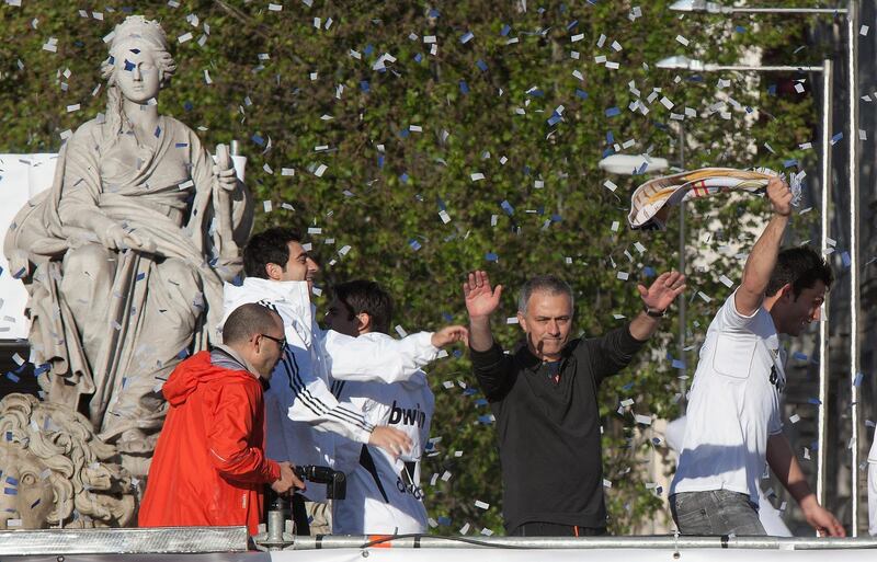 MADRID, SPAIN - MAY 03:  Head coach Jose Mourinho (R) of Real Madrid celebrates with supporters in Plaza de Cibeles on May 3, 2012 in Madrid, Spain. Real Madrid are celebrating winning the Spanish Liga title for the first time since 2008, and for the 32nd time in their history.  (Photo by Pablo Blazquez Dominguez/Getty Images)