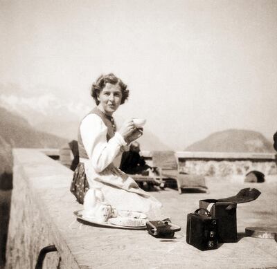 Eva Braun (1912 - 1945) sitting on a terrace in a Bavarian dress, at the Berghof, Hitler's residence, near Berchtesgaden, Germany, 1942. A box camera is next to her. She took many photos and also 16mm color film of life at the Berghof and elsewhere. (Photo by Galerie Bilderwelt/Getty Images)
