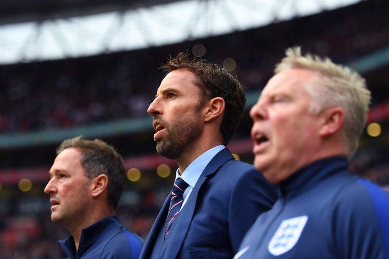England’s Gareth Southgate sings the national anthem ahead of the match. Laurence Griffiths / Getty Images