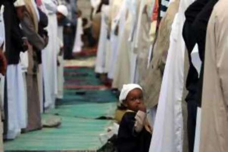 A young Muslim child joins hundreds of Kenyan Muslims who gathered at an open ground outside Masjid Noor in Nairobi, Kenya, Sunday, Sept. 20, 2009, for Eid Al Fitre prayers to mark the end of the holy month of Ramadan. (AP Photo/Sayyid Azim)