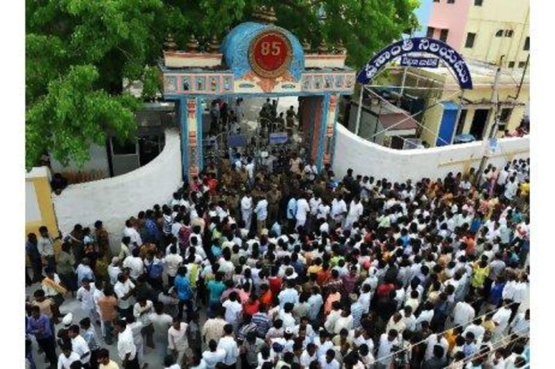Devotees wait to enter the ashram to pay their last respects to Sathya Sai Baba in Puttaparthi village, some 200kms north of Bangalore yesterday.