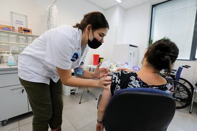 A woman receives her third dose of the Covid-19 vaccine in Israel. Boosters induce stronger immune responses, studies show. Reuters
