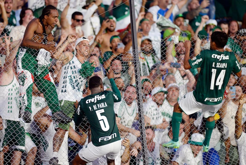 Palmeiras' Patrick de Paula and Gustavo Scarpa celebrate in front of fans. Reuters