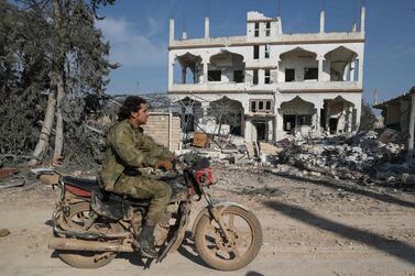 A Syrian rebel rides a motorcycle in Al Nayrab, south-east of the city of Idlib, on March 7, 2020. AFP