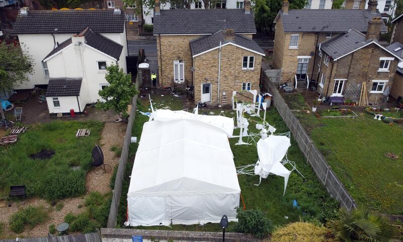 A tent at the back garden of a property in Peckham is seen as investigations continue. Reuters