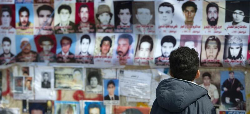 A child looks at the portraits of some of the 1,200 victims of the 1996 Abu Salim prison massacre by the regime in the Libyan rebel stronghold of Benghazi on April 2, 2011. Odd Andersen / AFP 