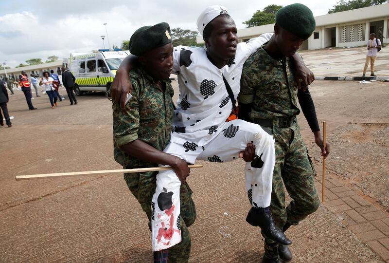 Policemen carry an injured man after police fired tear gas to try to control a crowd of people trying to force their way into a stadium to attend the inauguration of Kenya's president Uhuru Kenyatta at Kasarani Stadium in Nairobi, Kenya on November 28, 2017. Baz Ratner / Reuters