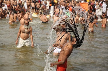 Hindus take ritualistic dips on the auspicious Makar Sankranti day during the Kumbh Mela, or pitcher festival, in Prayagraj, Uttar Pradesh state, India, Tuesday, Jan. 15, 2019. The Kumbh Mela is a series of ritual baths by Hindu holy men, and other pilgrims at the confluence of three sacred rivers — the Yamuna, the Ganges and the mythical Saraswati — that dates back to at least medieval times. The city's Mughal-era name Allahabad was recently changed to Prayagraj. (AP Photo/Rajesh Kumar Singh)