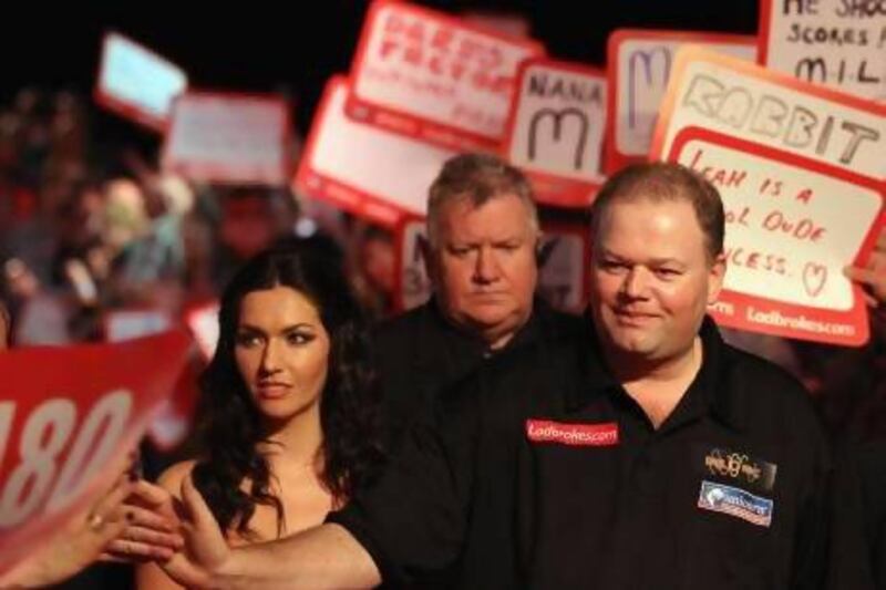 Raymond van Barneveld, right, of the Netherlands may not be a household name but at a darts event he enters the arena like a champion prize fighter coming to the ring.