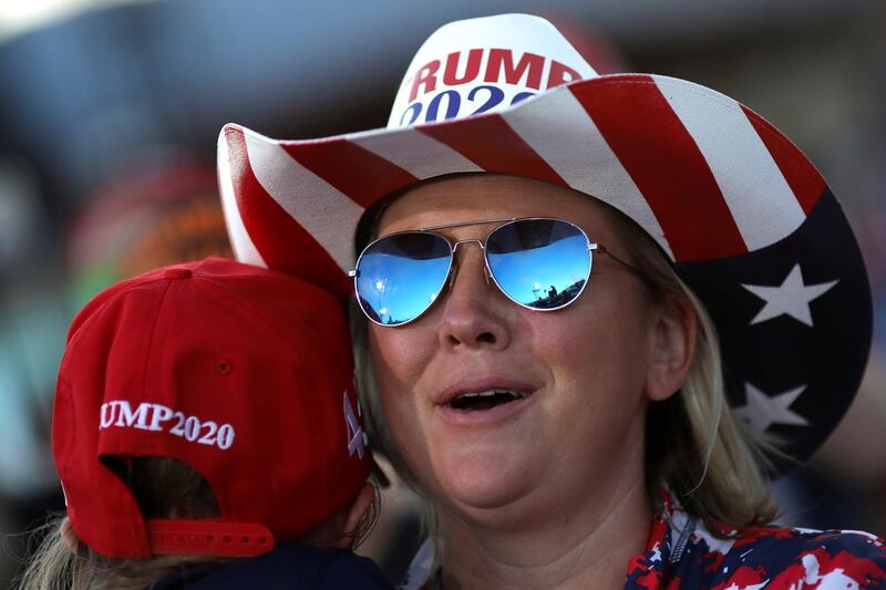 US President Donald Trump is seen reflected in the glasses of a supporter as he speaks during a campaign rally in Carson City. REUTERS