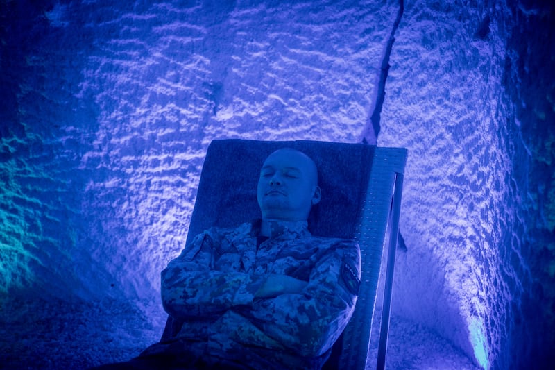 Oleksander, suffering from a hand injury, relaxes during a speleotherapy session, an alternative medicine respiratory therapy, at a rehabilitation center for soldiers in Kyiv, in October 2023. Getty Images