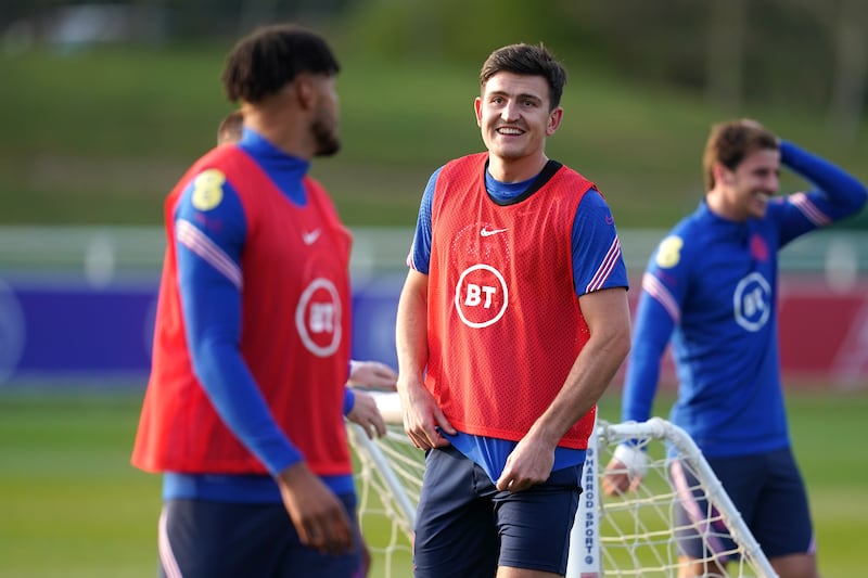 England defender Harry Maguire speaks with Tyrone Mings. PA