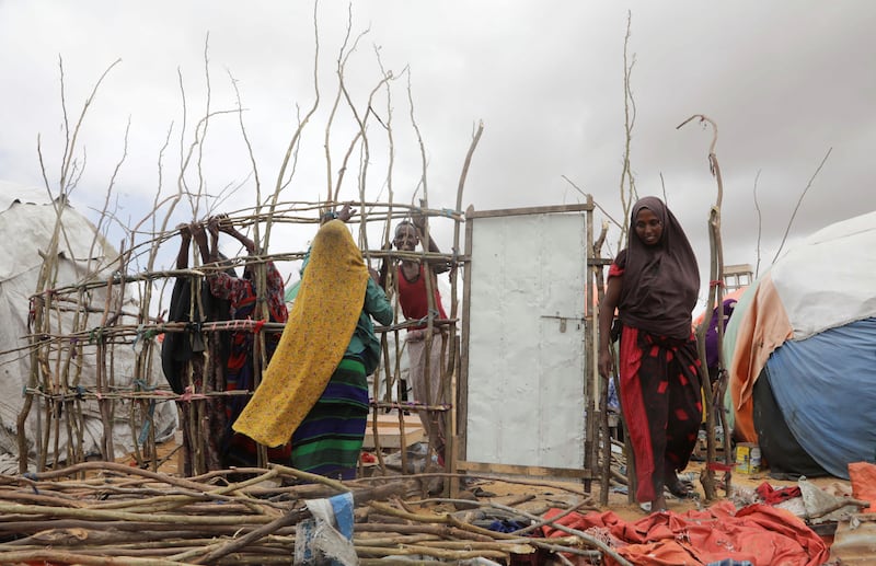 People build a makeshift shelter.