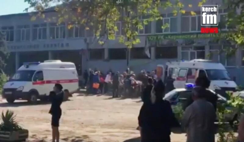 In this image made from video, showing the scene as emergency services load an injured person onto a truck, in Kerch, Crimea, Wednesday Oct. 17, 2018.  An explosive device has killed several people and injured at least 50 others at a vocational college in Crimea Wednesday in what Russian officials have called a possible terrorist attack. (Kerch FM News via AP) KERCH.FM LOGO CANNOT BE OBSCURED