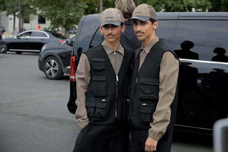 The Emirati Hadban twins arrive to attend the Givenchy show. AFP