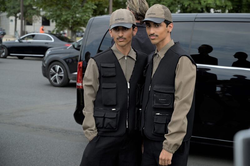 The twins arrive to attend the Givenchy menswear spring/summer 2023 show as part of Paris Fashion Week, on June 22, 2022. AFP