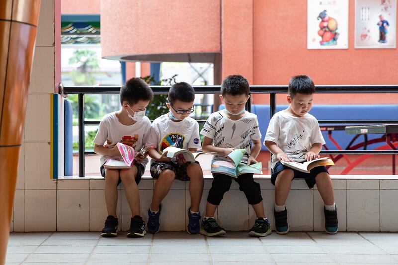 Pupils are seen reading books on the first day of the new semester in Wuhan in China's central Hubei province. AFP