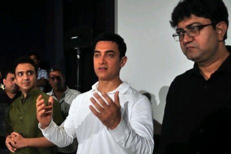 Indian Bollywood actor Aamir Khan (C), Ram Sampath (L) and Prasoon Joshi (R) attend a promotional event for the song "Satyamev Jayate Satyamev Jayate" for his reality television show in Mumbai.