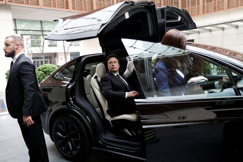 Billionaire Elon Musk gets in a Tesla car as he leaves a hotel in Beijing, China, on May 31, 2023. Reuters