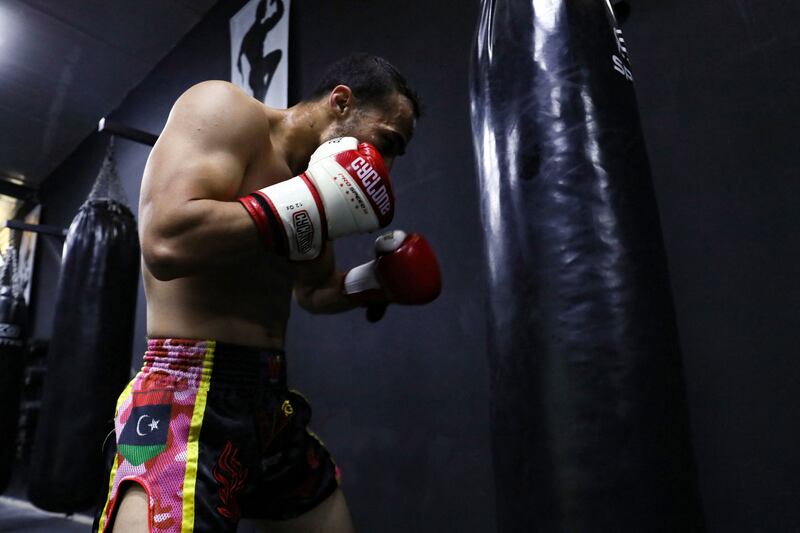 Kickboxer and Thai boxer Omar Bouhwiyah, is pictured during a training session at a gymnasium in Tripoli, on March 5, 2023.  - Libya's previous regime considered boxing too violent.  But since the 2011 revolution, Libyan boxers have shone in various competitions, modelling themselves of Malik Zinad, a light heavyweight fighter who found success after leaving the country for Europe.  (Photo by Mahmud Turkia  /  AFP)